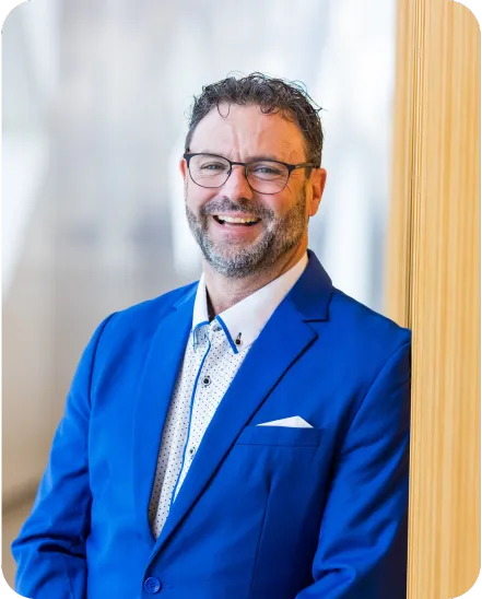 owner in royal blue suit